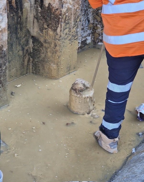 Worker in excavation pit hydro vac Sydney