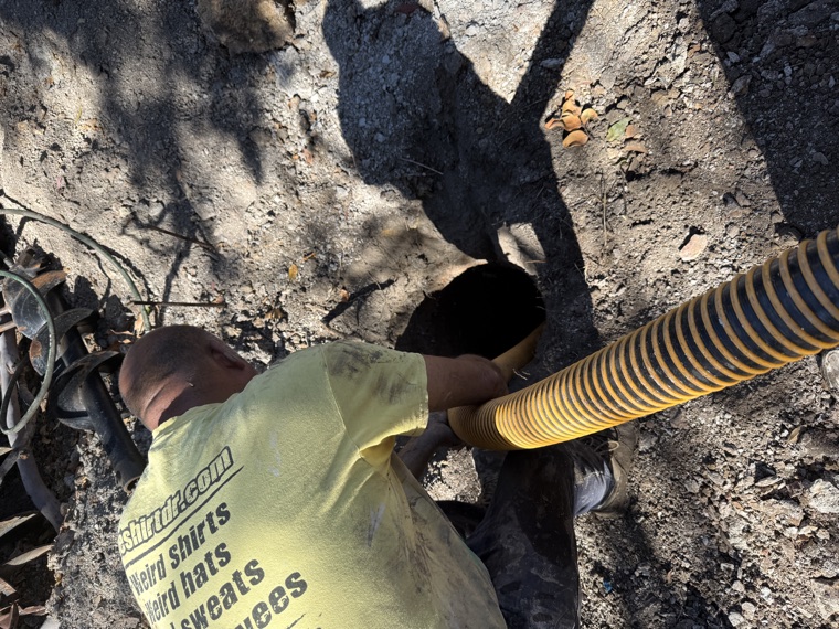 Operator using vac hose to expose underground service Sydney